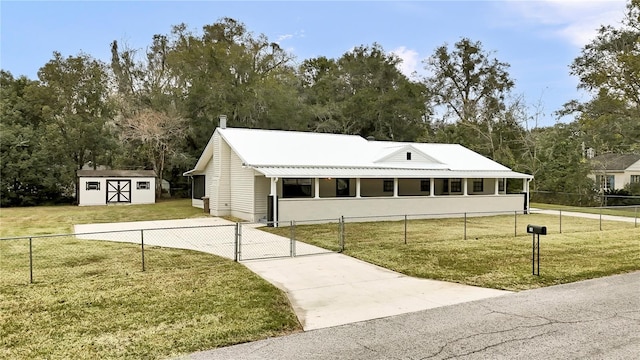 view of front of house with a front lawn and a shed