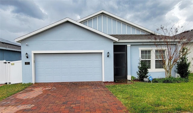 view of front of home with a front yard and a garage