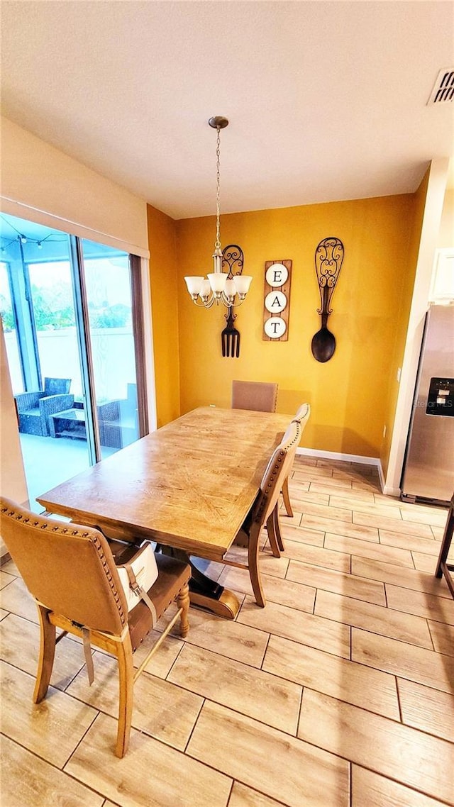 dining space featuring a notable chandelier