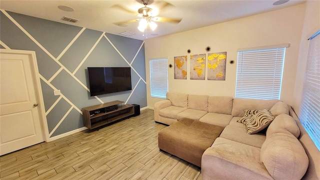 living room featuring ceiling fan and hardwood / wood-style flooring