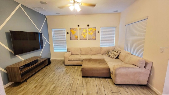 living room with light wood-type flooring and ceiling fan