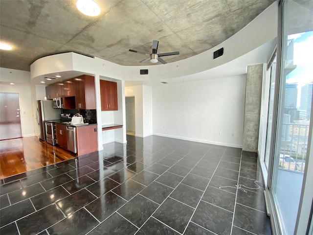 interior space with ceiling fan, appliances with stainless steel finishes, dark hardwood / wood-style flooring, and tasteful backsplash