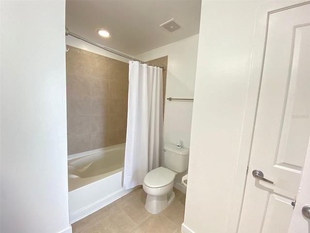 bathroom featuring toilet, tile patterned flooring, and shower / tub combo with curtain