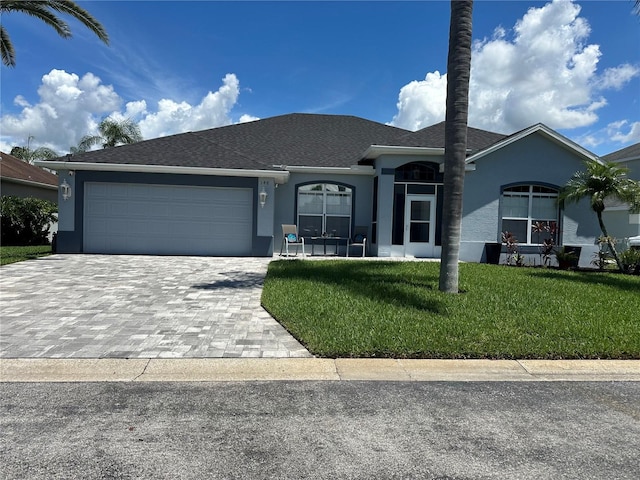 view of front of property with a garage and a front lawn