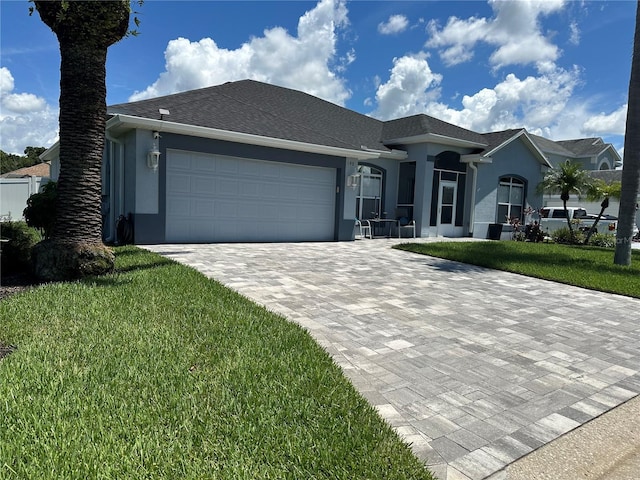 view of front of home featuring a garage and a front lawn