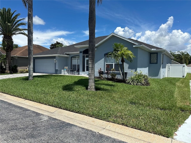 view of front of home with a front lawn and a garage