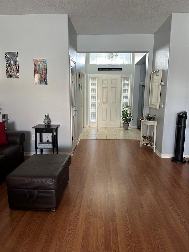 entryway featuring hardwood / wood-style flooring and a textured ceiling