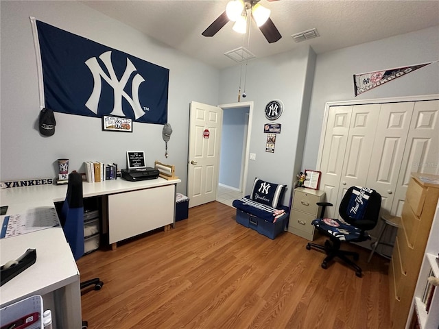 office space featuring a textured ceiling and light wood-type flooring