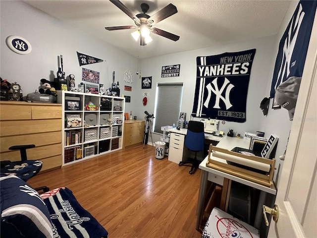 office featuring a textured ceiling, ceiling fan, and hardwood / wood-style floors