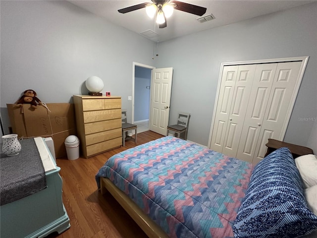 bedroom with ceiling fan, a closet, and hardwood / wood-style floors