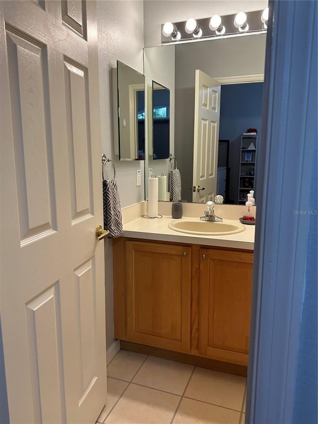 bathroom featuring tile patterned floors and vanity