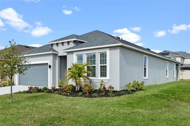 view of front of home with a front yard and a garage