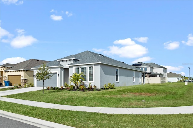 view of front of property featuring a front yard and a garage