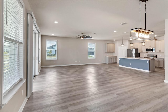 unfurnished living room with ceiling fan and light hardwood / wood-style floors