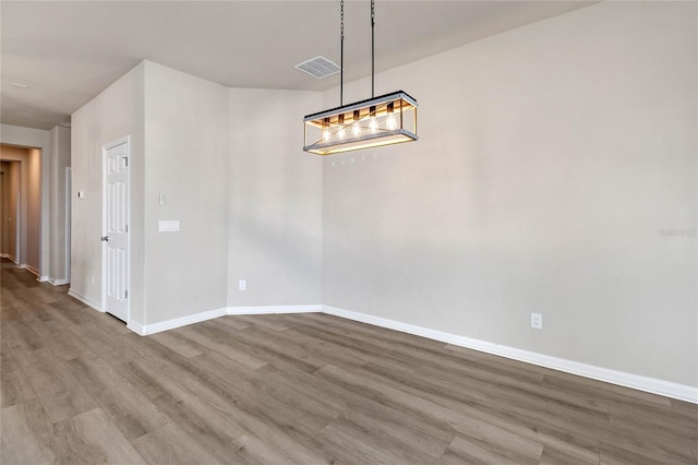 unfurnished dining area featuring hardwood / wood-style floors