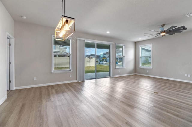 unfurnished room with light wood-type flooring and ceiling fan