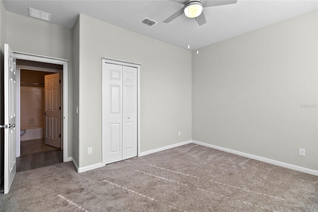 unfurnished bedroom featuring ceiling fan, a closet, and carpet