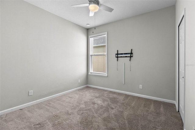 carpeted empty room with ceiling fan