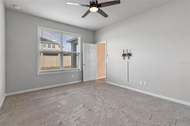 carpeted empty room with ceiling fan