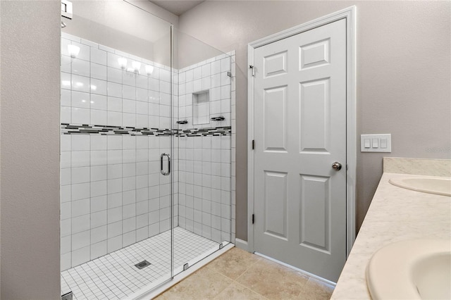 bathroom featuring walk in shower, tile patterned flooring, and vanity