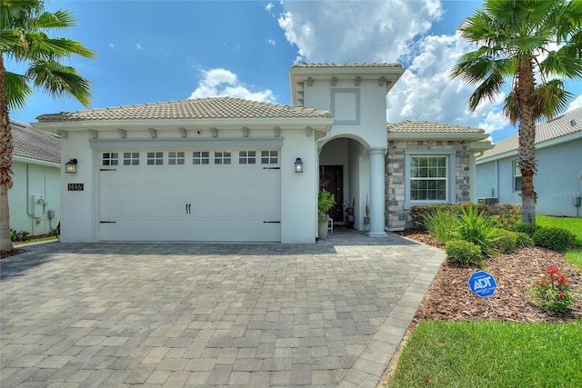 mediterranean / spanish-style house with a garage