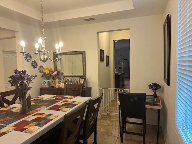 dining room featuring light tile patterned floors and a chandelier