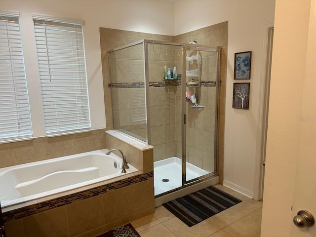 bathroom featuring plus walk in shower and tile patterned flooring