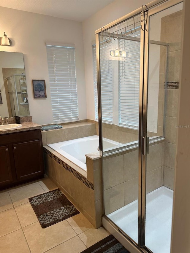 bathroom with tile patterned flooring, vanity, and shower with separate bathtub