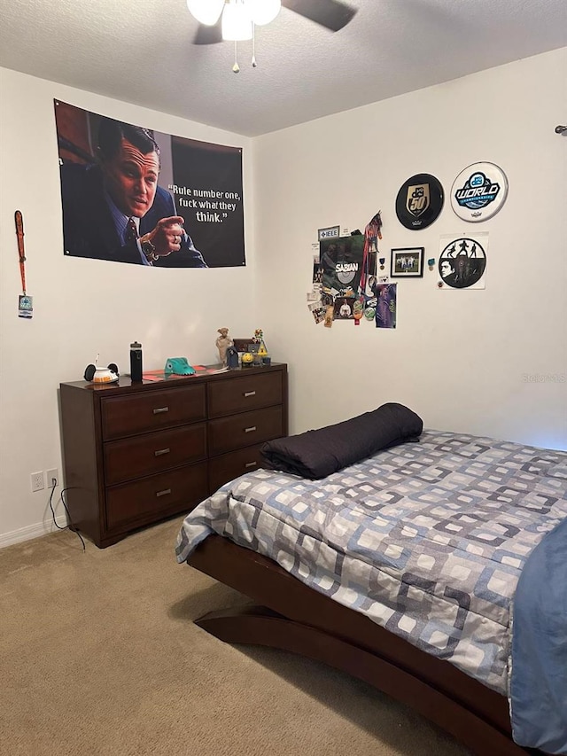 bedroom featuring ceiling fan and light carpet