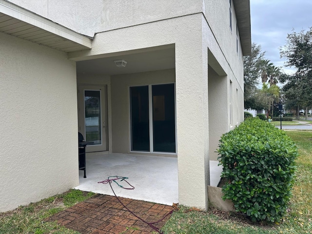 doorway to property with a patio area