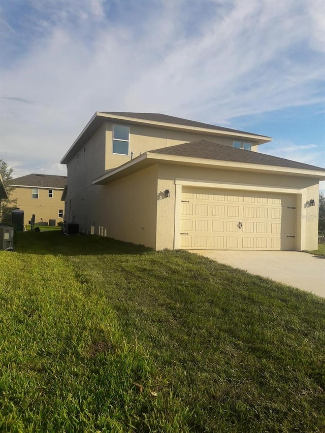 view of property exterior with a lawn and a garage