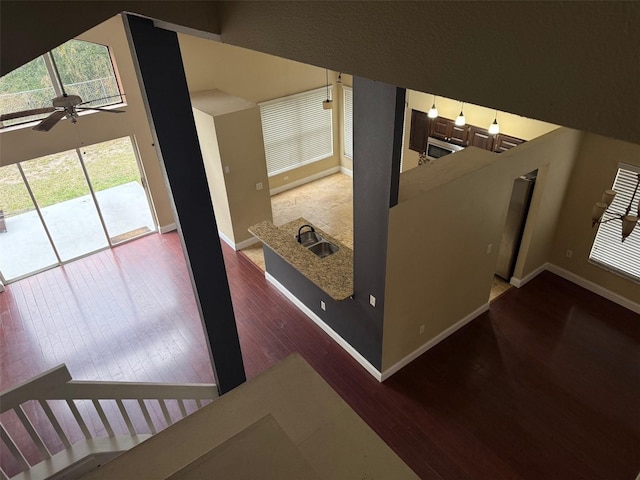 interior space featuring sink, wood-type flooring, and ceiling fan