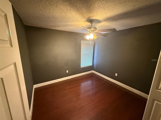 spare room with a textured ceiling and hardwood / wood-style floors