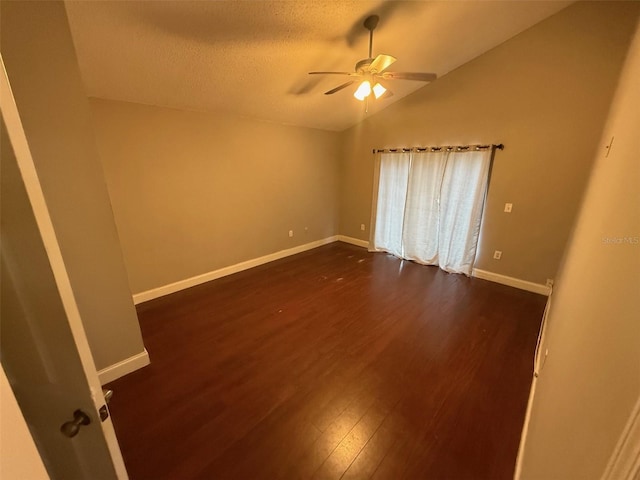 spare room with lofted ceiling, a textured ceiling, ceiling fan, and dark hardwood / wood-style floors