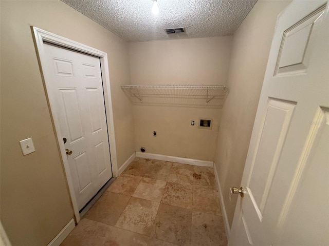 clothes washing area featuring washer hookup, hookup for an electric dryer, and a textured ceiling