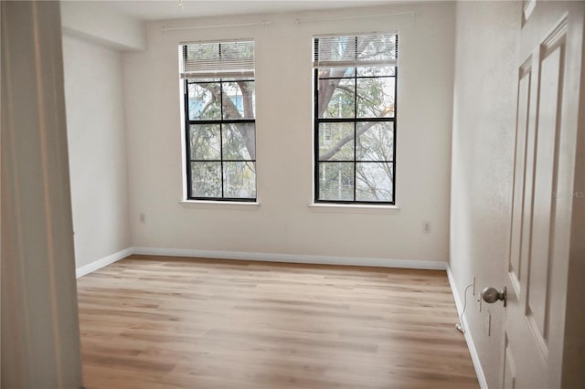 empty room with light hardwood / wood-style flooring