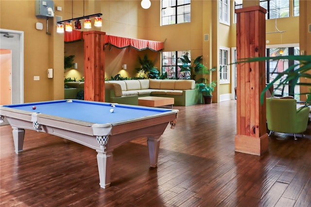 game room featuring dark wood-type flooring, billiards, and a towering ceiling