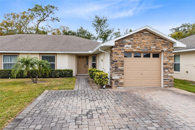 single story home featuring a garage and a front yard