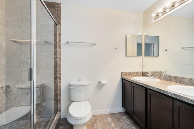 bathroom with toilet, vanity, and an enclosed shower