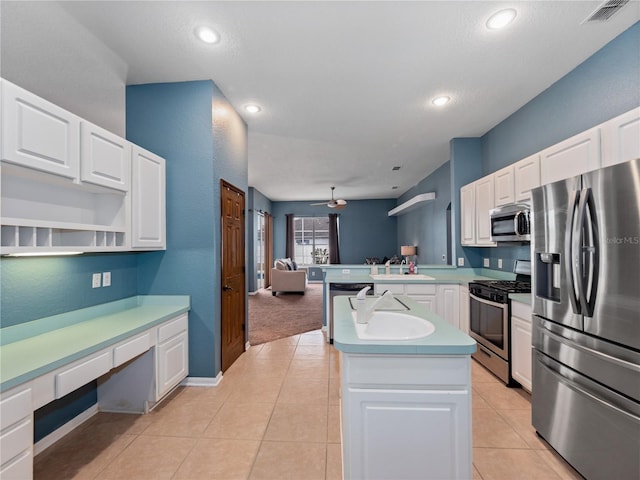 kitchen featuring ceiling fan, white cabinets, appliances with stainless steel finishes, and light tile patterned flooring