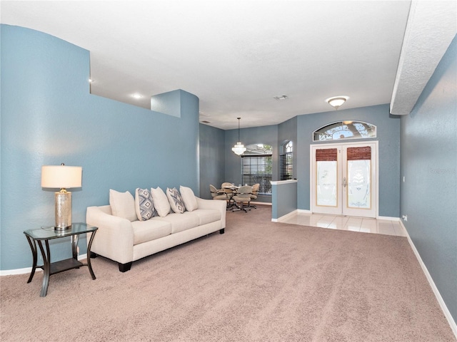 carpeted living room featuring french doors