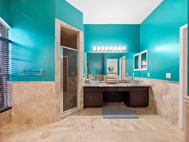 bathroom featuring vanity, tile walls, and walk in shower