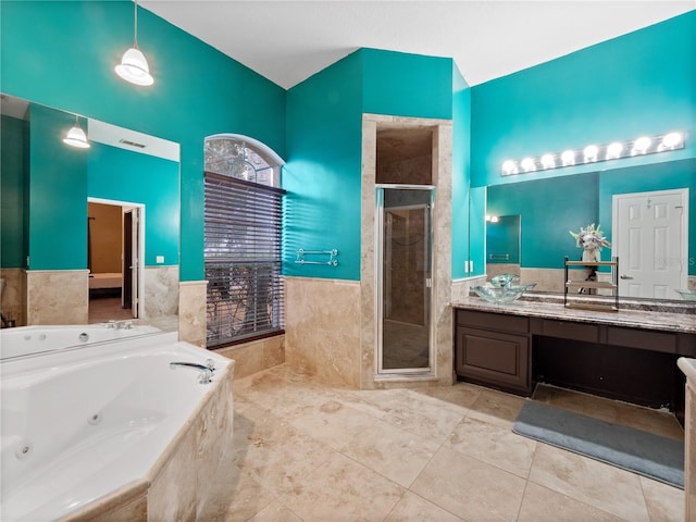 bathroom with tile patterned floors, vanity, lofted ceiling, and plus walk in shower