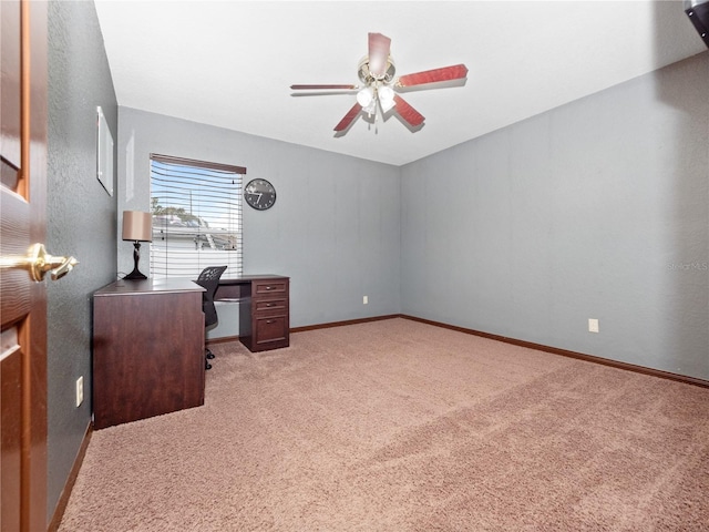 carpeted office space with ceiling fan