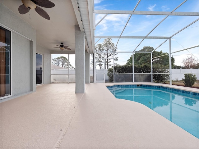 view of swimming pool with a lanai, ceiling fan, and a patio