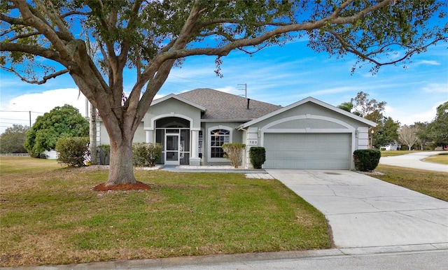 ranch-style home featuring a garage and a front lawn