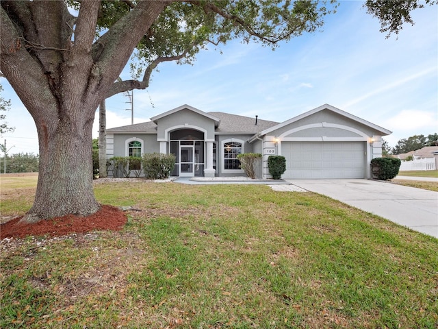 ranch-style home with a garage and a front lawn