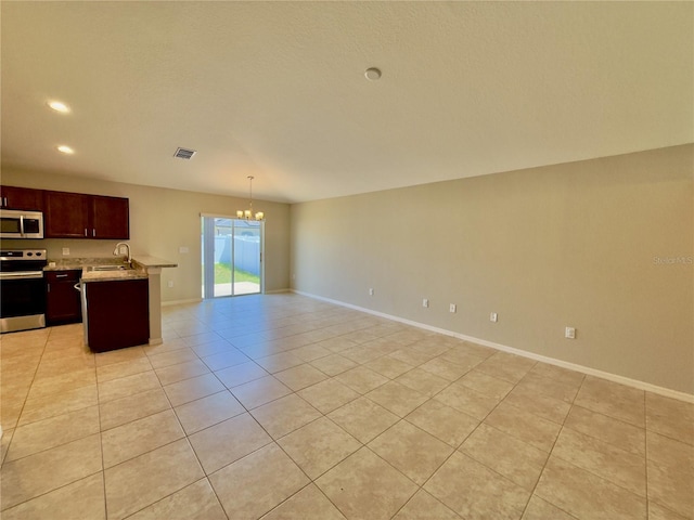 505 Pentas Ln, Haines City, FL 33844 - kitchen with stainless steel appliances, a sink, open floor plan, a chandelier, and light tile patterned flooring