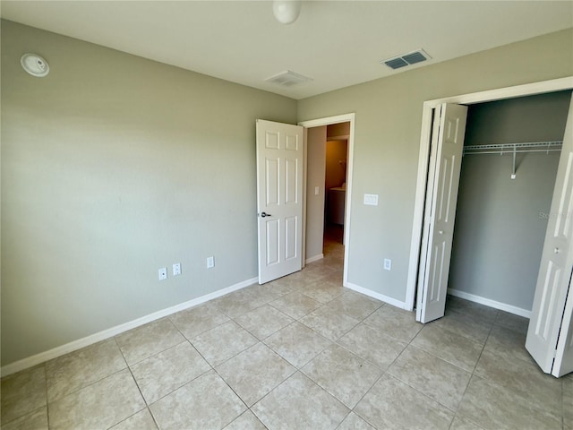 505 Pentas Ln, Haines City, FL 33844 - unfurnished bedroom with light tile patterned flooring, baseboards, and a closet