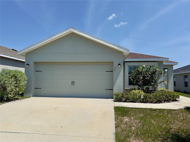 505 Pentas Ln, Haines City, FL 33844 - single story home with driveway, a garage, and stucco siding